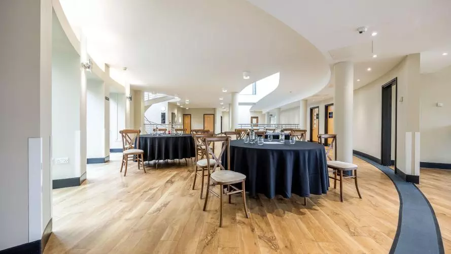 First Floor Mezzanine - event space laid out with round tables cabaret style