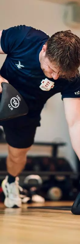 Man exercising with kettle bells