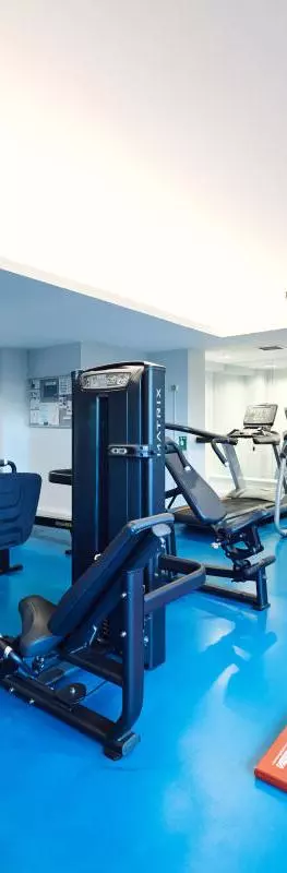 View into the University Club Gym showing the dumbell weights, weights machines and running machines