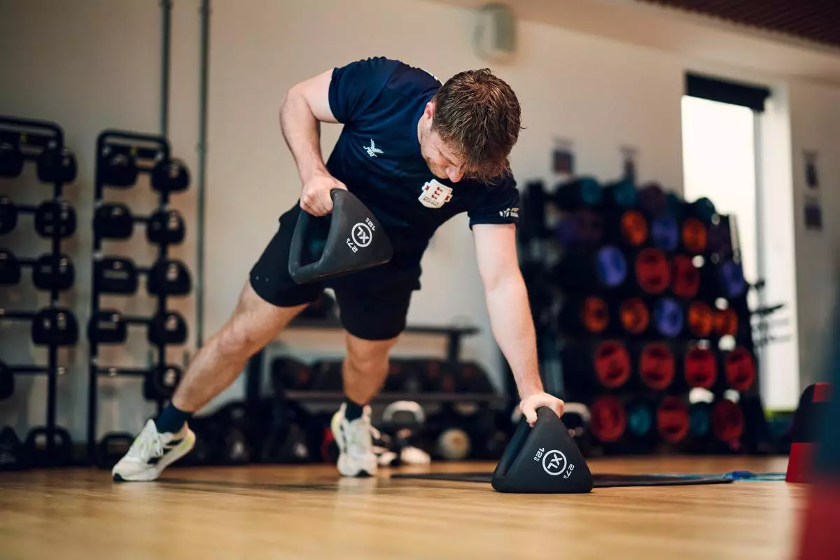 Man exercising with kettle bells