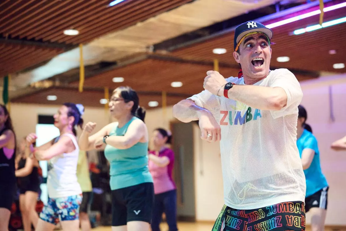 Zumba instructor smiling and leading an exercise class